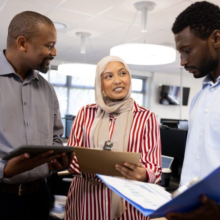 Happy diverse female and male businesspeople talking and working in office. Business, corporation, cooperation and working in office concept.